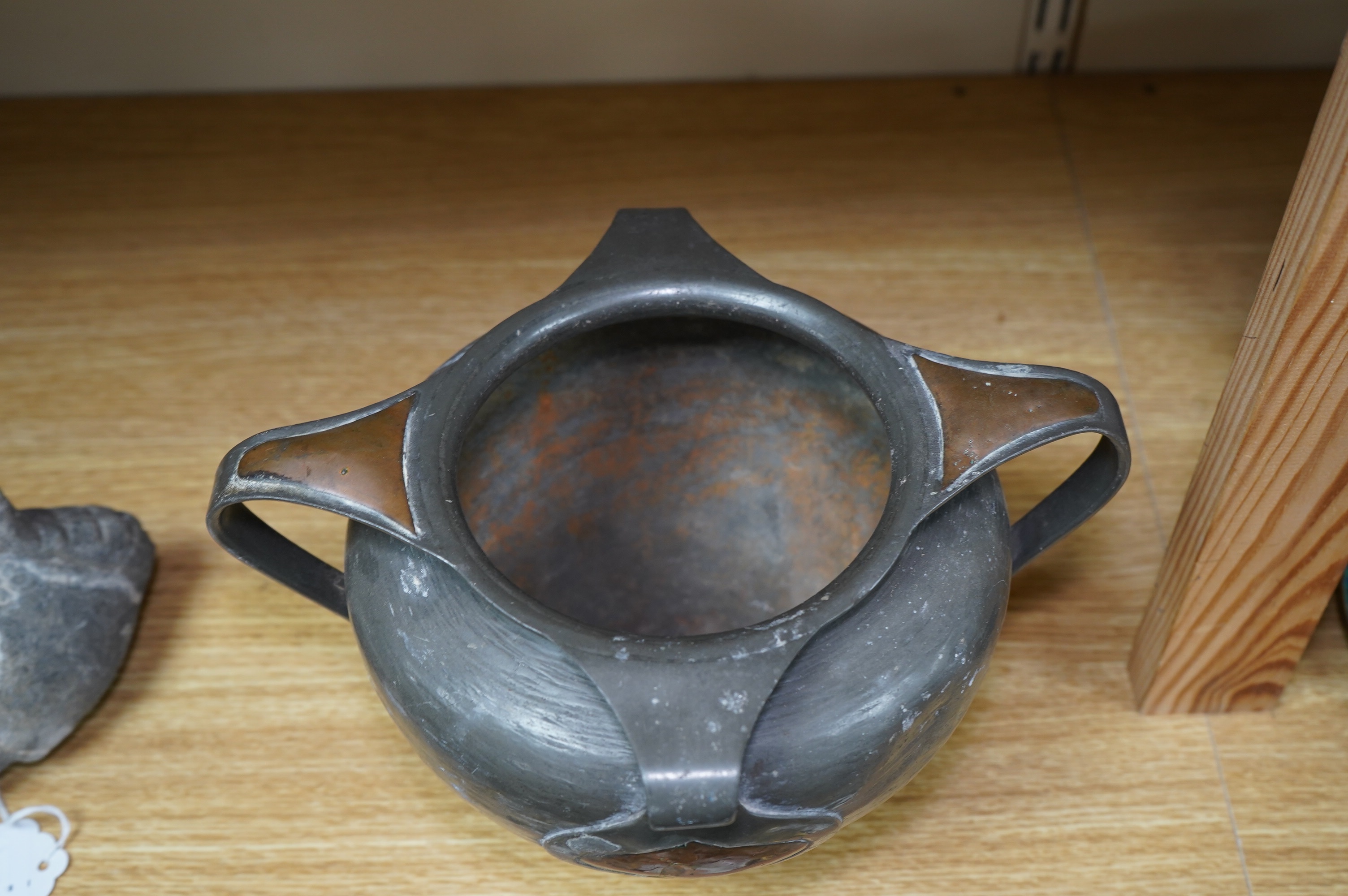 Oliver Baker for Liberty & Co, a Tudric pewter and copper vase, no.0864, c.1910, 25cm wide. Condition - fair to good